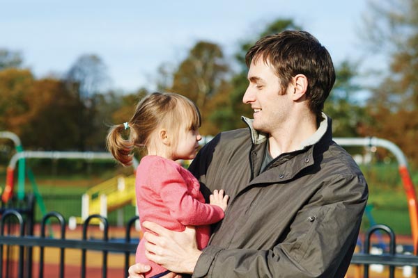 man with daughter in park